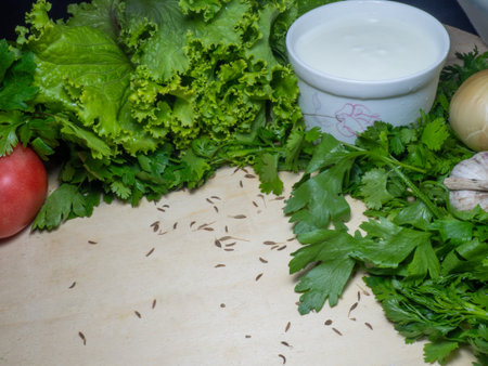 Greens for soup on the table. Greenery from the garden. cutting board. Cooking. Vegan food. Useful...