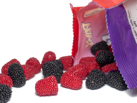 Batumi, Georgia. 18/07/2022 Marmalade in the form of berries on a white background. Blackberry and raspberry. Sweets in the form of blackberries and raspberries with packaging. Tasty food. sugar.のeditorial素材