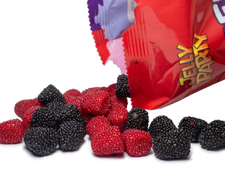 Batumi, Georgia. 18/07/2022 Marmalade in the form of berries on a white background. Blackberry and raspberry. Sweets in the form of blackberries and raspberries with packaging. Tasty food. sugar.のeditorial素材
