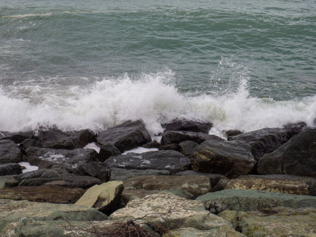 rocky seashore. The shore is fortified with huge stones. Large waves on the pier. Travel to Turkey. big waves. windy weatherの写真素材