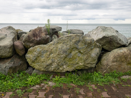 Barrier of large stones on the seashore. wave protection. Irregular stones. sea shore. viewの写真素材