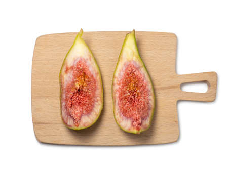 sliced figs on a cutting board. Juicy ripe fruit on a white background. Diet food. Figure isolate. Seeds inside.の写真素材
