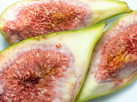 Pieces of chopped green figures. Juicy ripe fruit. diet food. Figure isolate. Seeds inside cut fruitの写真素材