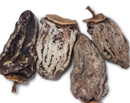 Dried persimmon on a white background. Dried fruits of the tree. Dried fruits isolate. pattern. Healthy food concept. Dieting. Place for an inscriptionの写真素材