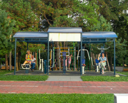 Batumi, Georgia. 13/08/2022 Place for sports in the city. Accessible outdoor exercise equipment. strength exercises. Bike path in the park. Infrastructure of a modern city. sports. Empty treadmill. Pedestrian crossing through the bike pathの写真素材