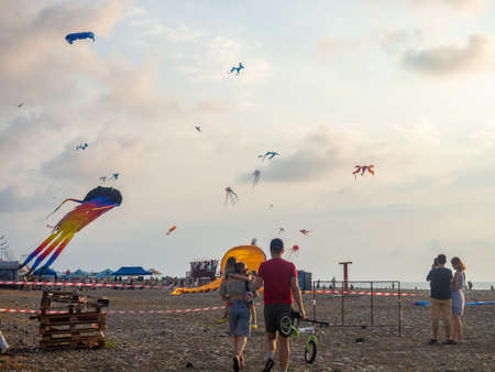 Batumi, Georgia. 08.13.2022 Kite Festival. People fly kites. Beauty in the sky Different kites in the sky. vacation at the resort. Festive mood.の写真素材