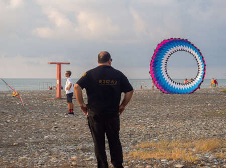 Batumi, Georgia. 13/08/2022 Parachutes on the ground. wind. kite festival. People fly kites. different kites in the sky. vacation at the resort.の写真素材