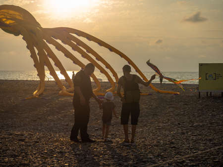 Batumi, Georgia. 13/08/2022 Festival of kites. Flying a huge kite in the shape of a squid. People fly kites. Beauty in the sky Place on the sea. Holiday by the seaの写真素材