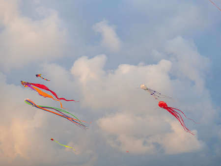 Lots of kites in the sky. kite festival. colorful toys. launch kits. Beauty in the sky Leisure entertainment. windy weatherの写真素材