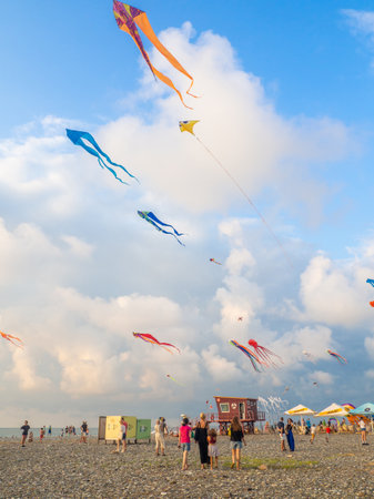 Batumi, Georgia. 08.13.2022 Lots of kites in the sky. Kite Festival. Colorful toys. People fly kites. Beauty in the sky  .  launches a kite .Entertainment on vacation. Windy weatherのeditorial素材