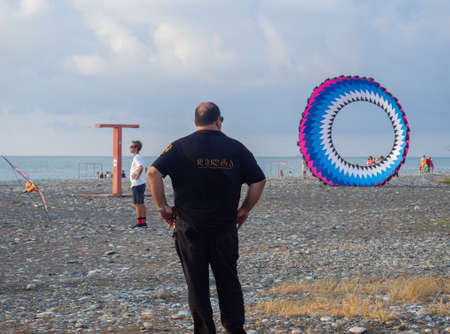 Batumi, Georgia. 13/08/2022 Parachutes on the ground. wind. kite festival. People fly kites. different kites in the sky. vacation at the resort.の写真素材