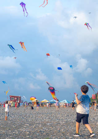 Batumi, Georgia. 13/08/2022 Lots of kites in the sky. colorful action. kite festival. colorful toys. Man launches a kite. Beauty in the sky Leisure entertainment. windy weatherの写真素材