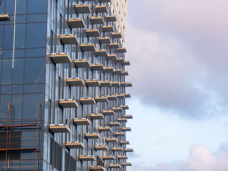 Part of a high-rise building under construction. End of construction. Finished works. Facade of a new beautiful skyscraper. modern engineering. resort townの写真素材