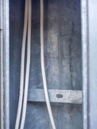wires inside. Wrapped contacts. electrical safety. Tape wrapping wires. Electricity of the net. Sticking wires inside the poleの写真素材