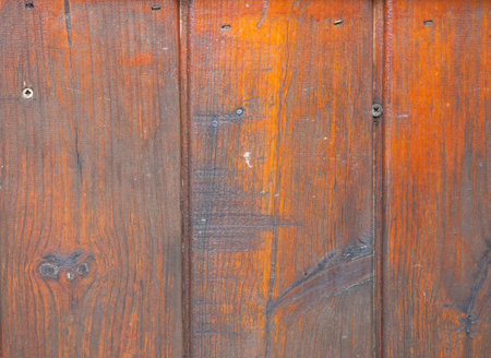 Background from solid material. Old nailed boards. Wooden wall finished. Uneven wall surface. Lacquered boards. old houseの写真素材