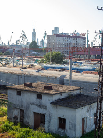 Batumi, Georgia. 08.30.2022 Railroad in the city. Abandoned scrap. Port cranes and high-rise buildings. Many railway paths. Wagons and trains on the tracks. unloading station. Batumi. Old metal structures. industrial zoneのeditorial素材