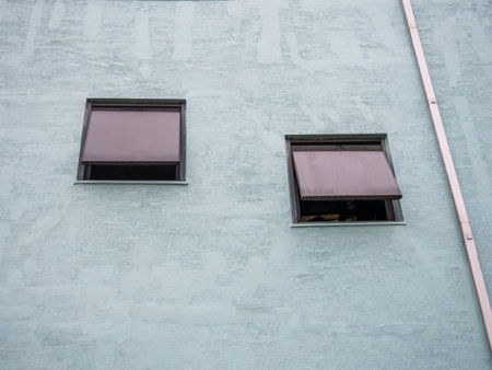 Window in a concrete wall. reflection in the window. glass and stone. Background from the wall. architecture. part of the buildingの写真素材