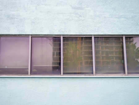 Window in a concrete wall. reflection in the window. glass and stone. Background from the wall....