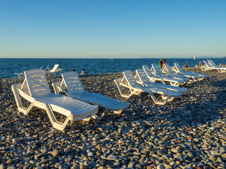 Beach beds. Folded beds. end of the season. On the Sunset. beach holidays. Resort by the sea.