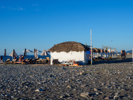 Batumi, Georgia. 09.09.2022 Beach vacation. Resort by the sea. Beach view. Tents and stalls on the beach.のeditorial素材