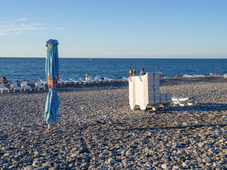 Batumi, Georgia. 09/09/2022 Beach beds. Folded beds. end of the season. On the Sunset. beach holidays. Resort by the sea.のeditorial素材