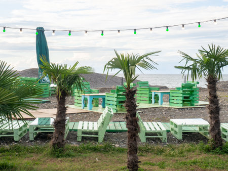 The interior of a street restaurant among palm trees. Cafe in green colors. vacation at the resort. fast food. Rest on the seashoreの写真素材