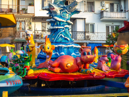 Spinning carousel with cartoon characters. entertainment in the park. Colorful boots. High above the...