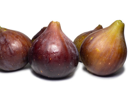 Ripe figs on a white background. Several figs. Southern fruit isolate. purple fruit. healthy diet.の写真素材