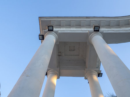 White arch and lanterns on it. architectural ensemble. decorative building. Arch at the entrance to the park. Beautiful decoration of the cityの写真素材