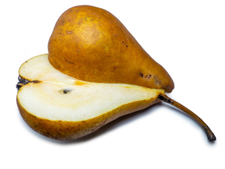 A pear cut in half. The pulp of a juicy fruit. Yellow pearl on a white background. Food for a raw food lover. Delicious snack. fruit abundanceの写真素材