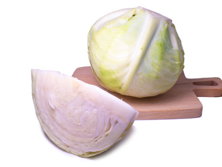 Pieces of white cabbage on a white background. From the garden. vegetable isolate. cut cabbage. Healthy lunch ingredient. Healthy food concept. An ingredient for borscht. Can be eaten rawの写真素材