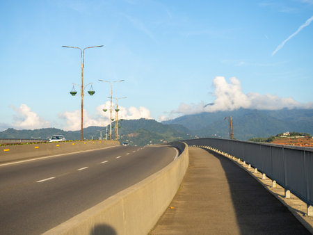 The road going up. Road junction against the backdrop of mountains. Asphalt pavement. machine movementの写真素材
