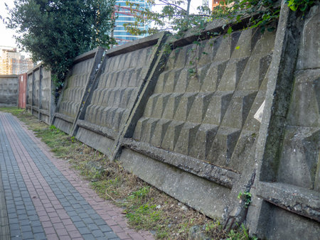 Reinforced concrete fence PO-2. Decayed concrete fence. Fallen fence. Cement. bad defenseの写真素材