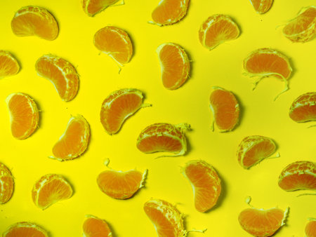 Background from slices of tangerines. Citrus abundance. yellow. fruit pulp concept. Parts of tangerinesの写真素材