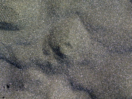 Background from black sand. Sand on the beach. Coast of the Black Sea. black materialの写真素材