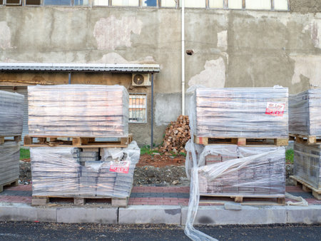 Batumi, Georgia. 04.11.2022 Pavement repair. Laying out paving stones. Paving stones in pallets in polyethylene. repair work.のeditorial素材