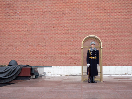 Moscow, Russia. 01/04/2022 Sentinel at the eternal flame. old red brickwork. Layers of stones. Kremlin wall. historical place. architectural monumentのeditorial素材