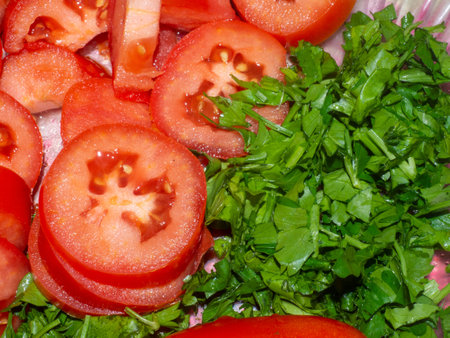 Juicy ripe tomato cut into slices. finely chopped parsley. Snack on the table. Harvest from the garden. Slicing vegetablesの写真素材