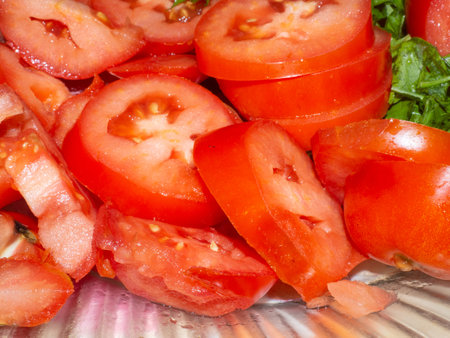 Juicy ripe tomato cut into slices. finely chopped parsley. Snack on the table. Harvest from the garden. Slicing vegetablesの写真素材
