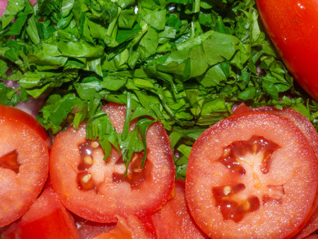 Juicy ripe tomato cut into slices. finely chopped parsley. Snack on the table. Harvest from the garden. Slicing vegetablesの写真素材