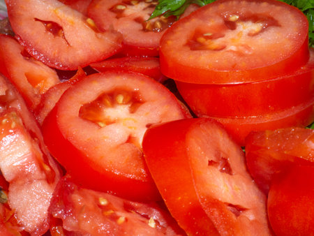 Juicy ripe tomato cut into slices. finely chopped parsley. Snack on the table. Harvest from the garden. Slicing vegetablesの写真素材