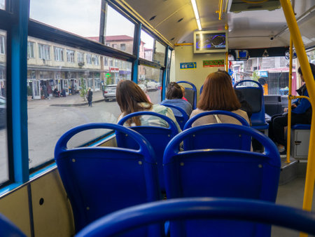 Batumi, Georgia. 21/11/2022 People sitting with their backs in an empty bus. The concept of public transport. Empty interior of the bus. urban transportのeditorial素材