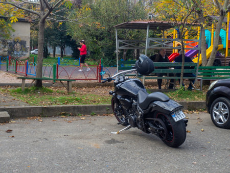 Batumi, Georgia. 21/11/2022 The motorcycle is parked in front of the house. A new beautiful motorcycle in the yard of an old house. Means of transportation without a driverのeditorial素材