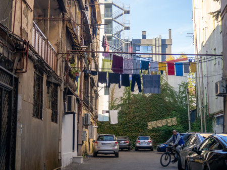 Batumi, Georgia. 11.23.2022 Street scene. Clothes are dried on a line. colorful houses. urban environment. Beautiful sunny day in the city. road trafficのeditorial素材