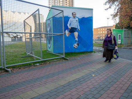 Batumi, Georgia. 23/11/2022 A woman passes near the stadium. beautiful place. stadium exterior. sports facility. modern architectureのeditorial素材