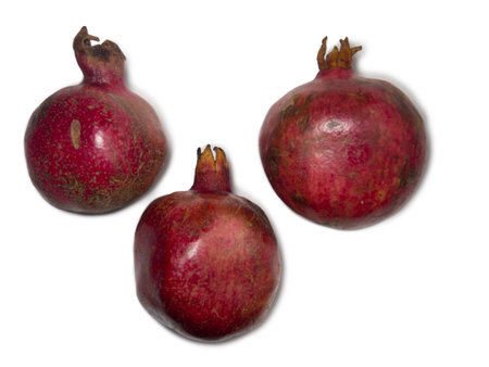 Pomegranate on a white background. Juicy fruit with seeds. Whole red fruit. pomegranate isolate. Juice ingredient. Vegetarianismの写真素材