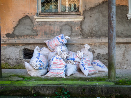 Batumi,Georgia. 01/12/2022 Bags with construction debris against the wall. White eats are filled with something. after repair. trashのeditorial素材