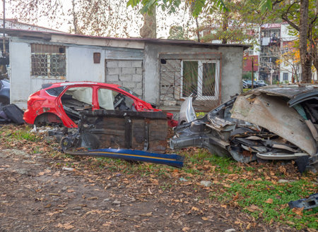 Broken cars near the car workshop. Cars in the landfill. A pile of scrap metal. Former transport.