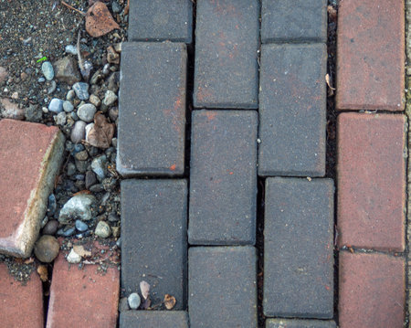 Broken paving stone. Broken pavement stones. Poor quality work. masonry. The need for repairの写真素材