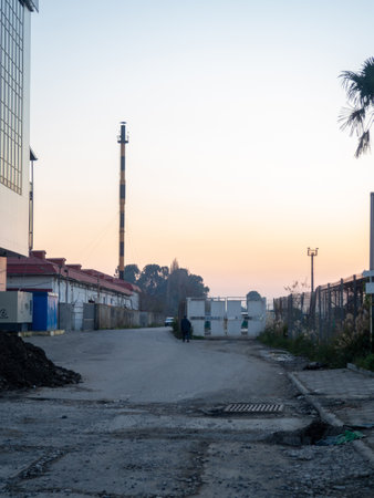 Outskirts. Batumi. industrial zone. The man is walking along the road. broken roadの写真素材